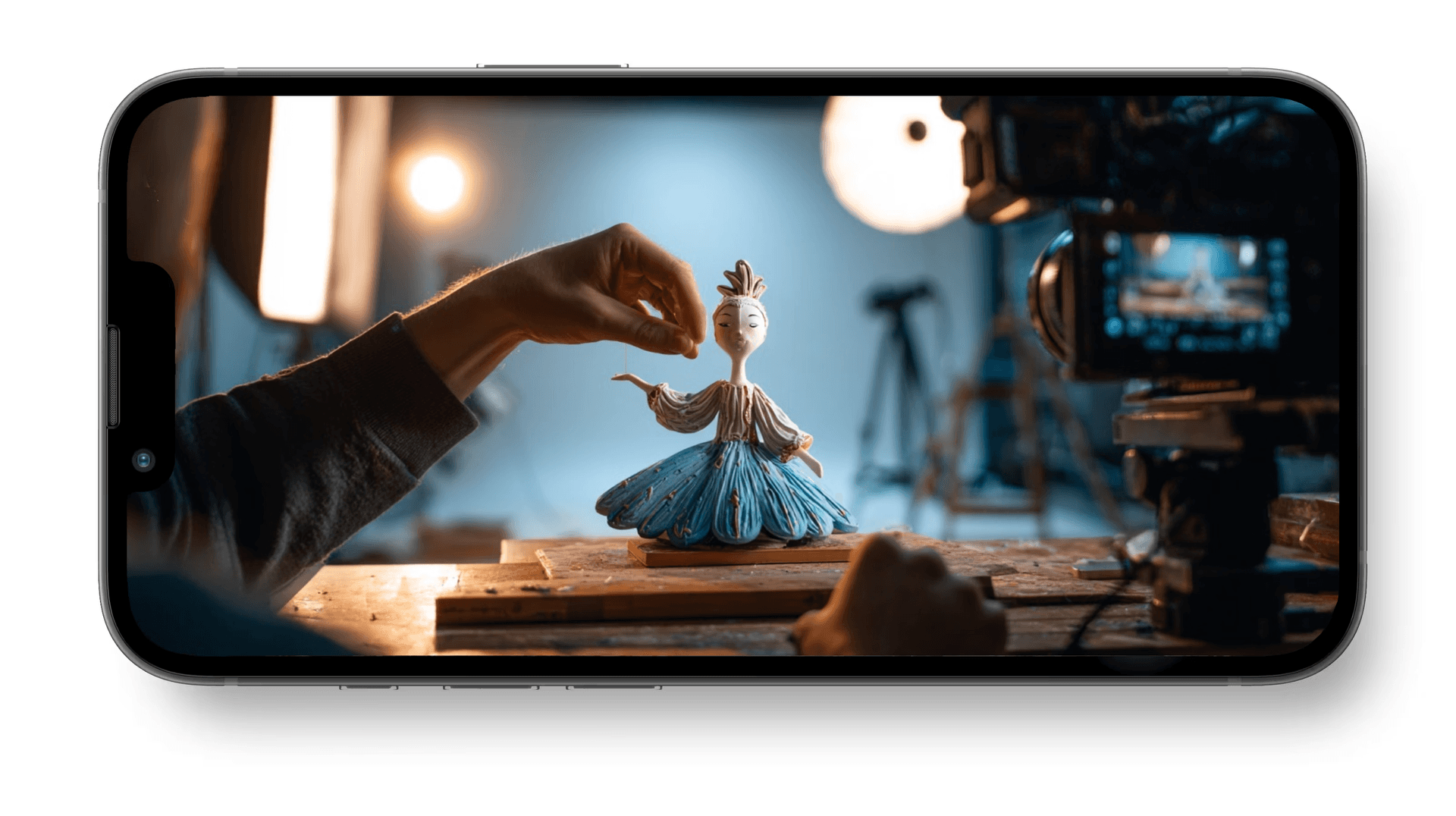 Filmmaker crafting a stop-motion puppet on set